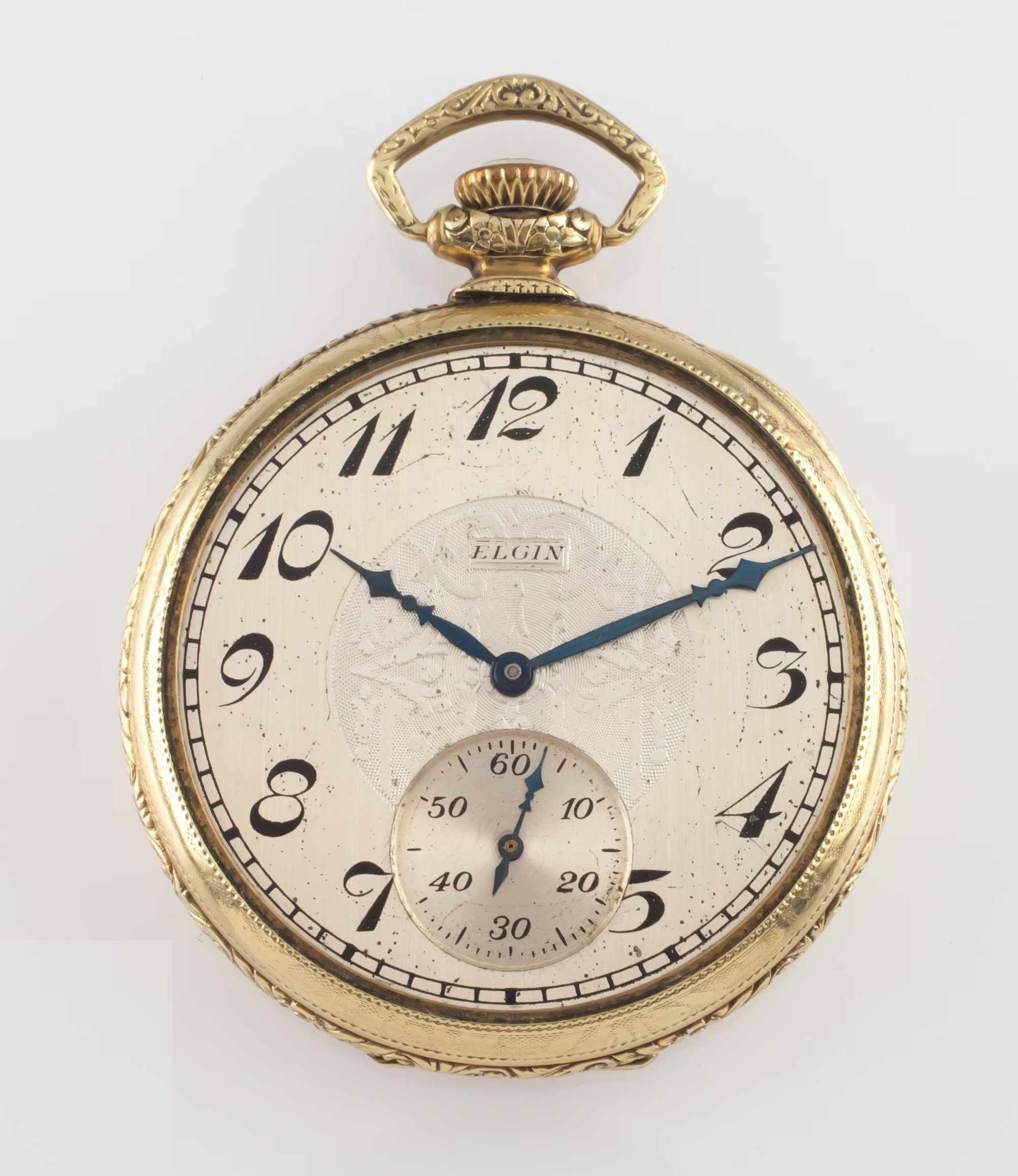 An antique gold pocket watch with a white enamel dial