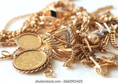 A pile of gold chains, rings and coins