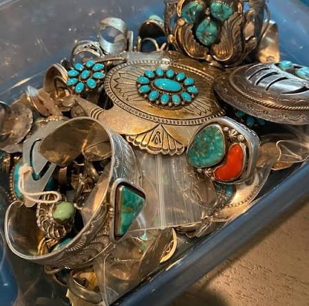 A pile of sterling silver and turquoise jewelry